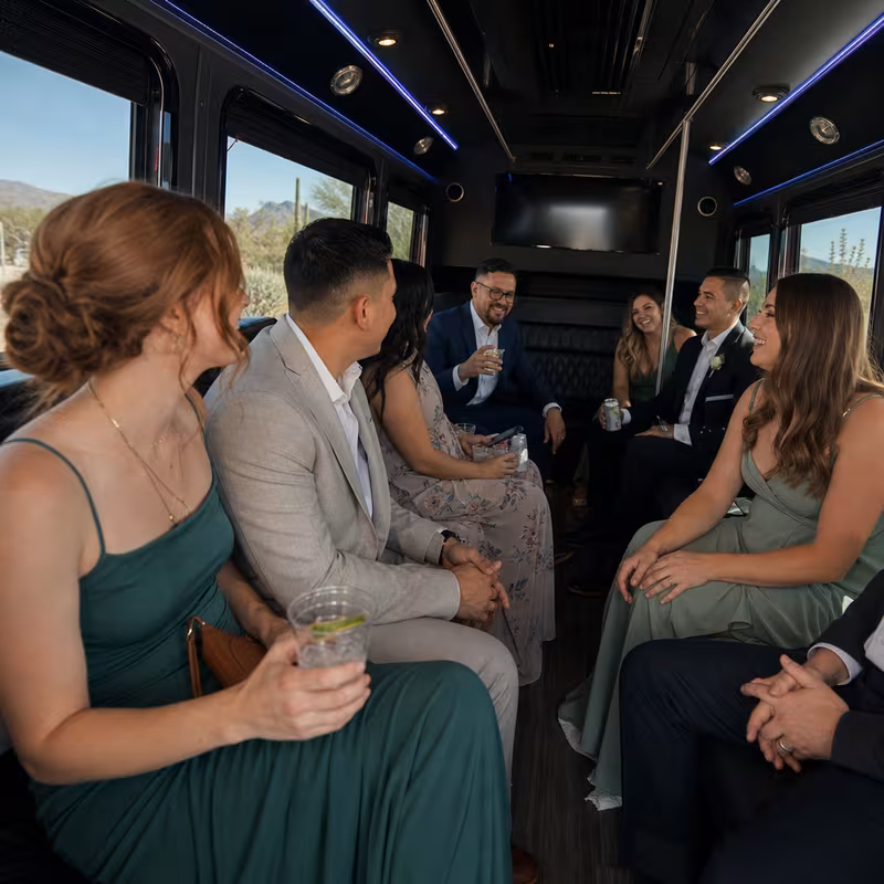 Wedding guests seated inside a Tucson party bus