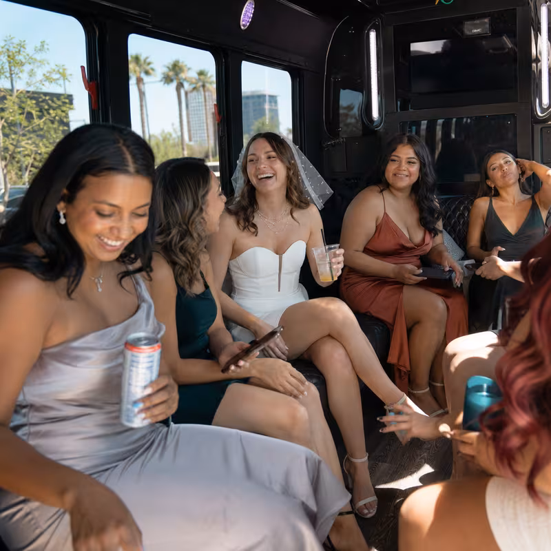 Party bus interior with wraparound leather seating and LED lighting in Tucson