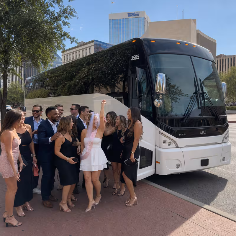 Passengers loading luggage while boarding an Tucson group shuttle