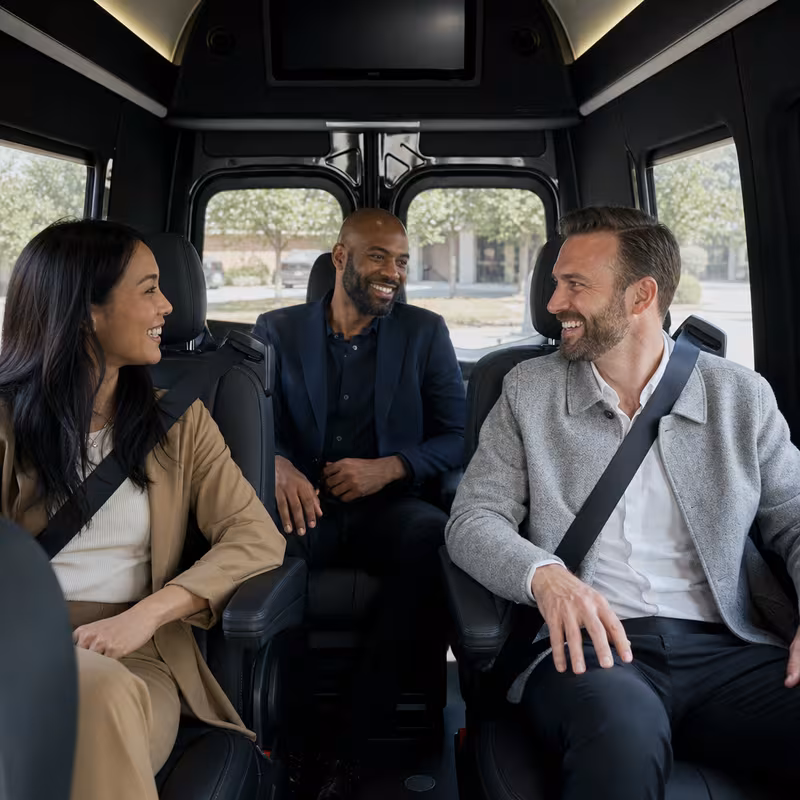 Group boarding a white charter bus for Corporate Transportation transportation in Tucson