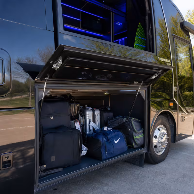 Party bus interior with wraparound leather seating and LED lighting in Tucson