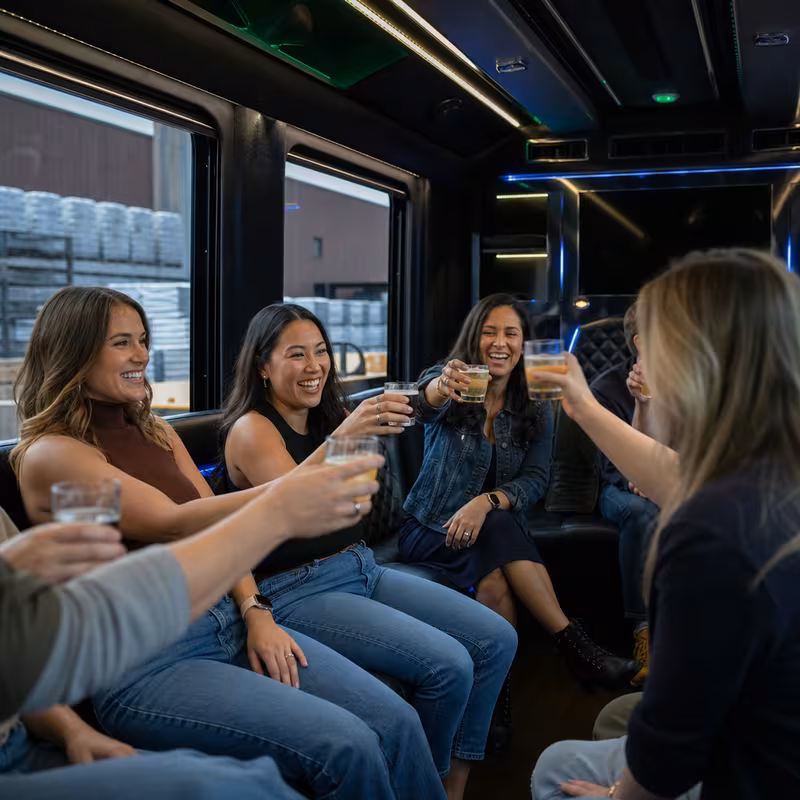 Group boarding a white charter bus for Winery & Brewery Tour Transportation transportation in Tucson