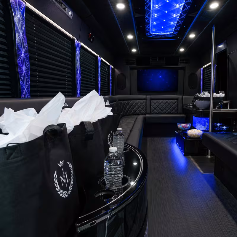 Party bus interior with wraparound leather seating and LED lighting in Tucson